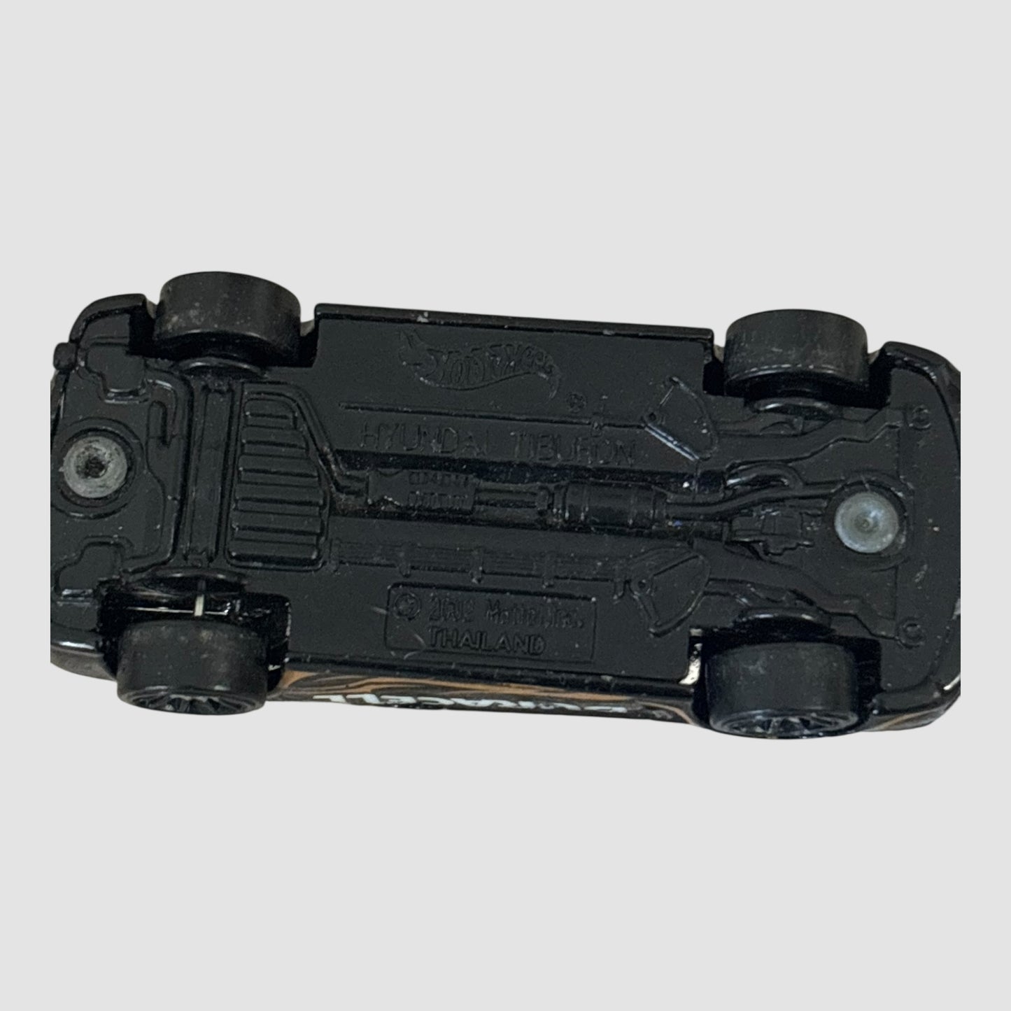 Carro miniatura Hot Wheels Hyundai Tiburon Duracell preto e dourado
